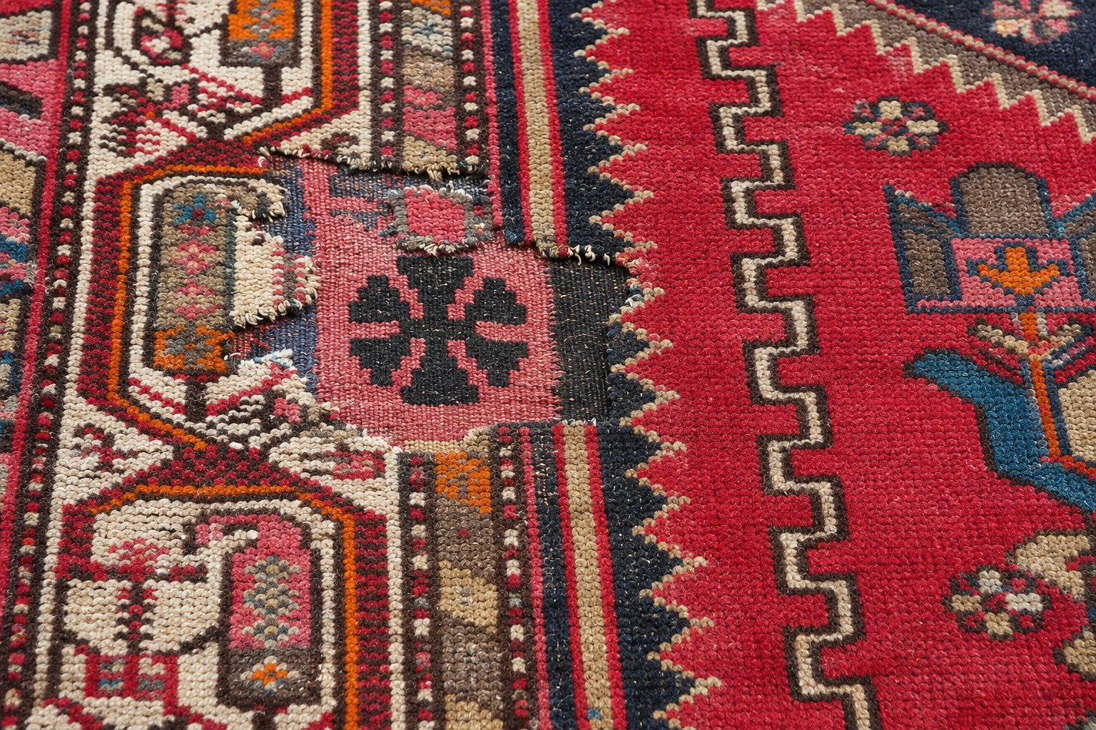 Replacement fabric piece placed into the damaged area before stitching begins